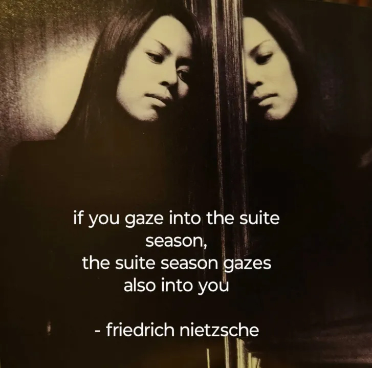 Takanori Nishikawa staring at his own reflection in a mirror with the text 'if you gaze into the suite season, the suite season gazes also into you - friedrich nietzsche'